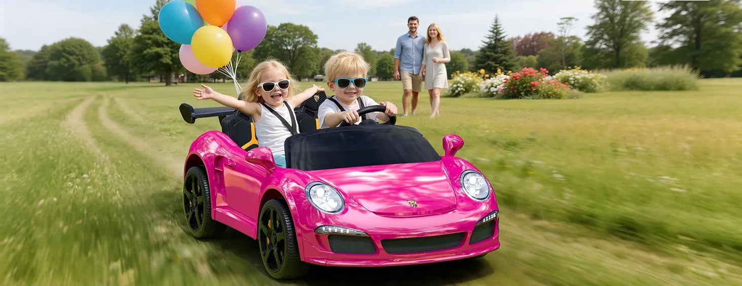 Children in a pink toy car with balloons in a park setting